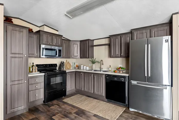 a kitchen with stainless steel appliances granite countertop a refrigerator stove a sink and dishwasher