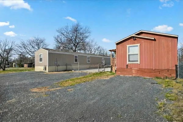 a view of a house with a yard and garage