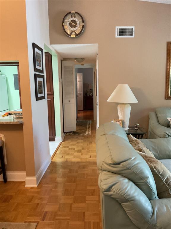2655 Pine Ridge Way North, Unit D3 Palm Harbor, FL 34684 - Photo 5 of 31 a bedroom with a bed and a chandelier