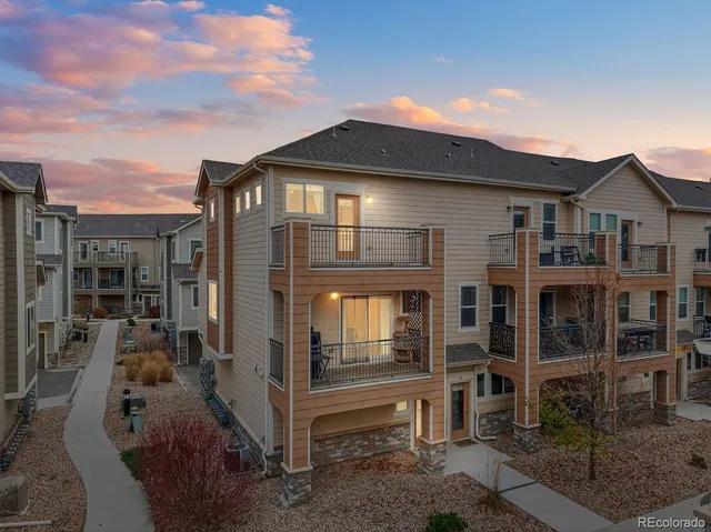 a front view of a house with glass windows and brick walls
