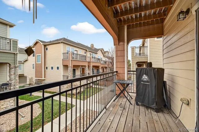 a view of a balcony with chairs and wooden floor