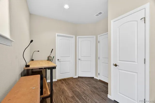 a view of a room with wooden floor table and chairs