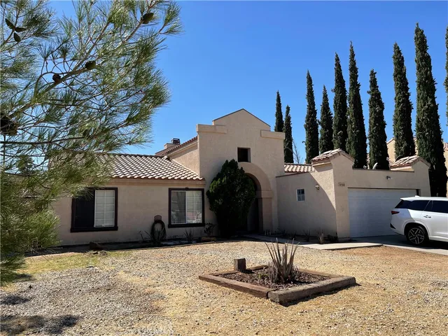 a backyard of a house with table and chairs