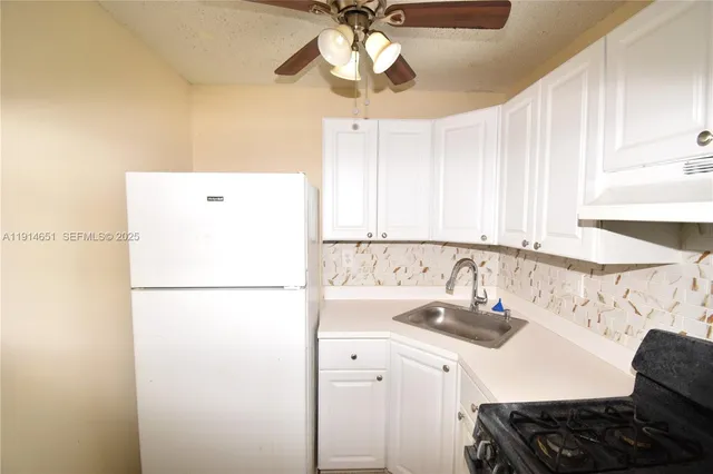 a kitchen with a refrigerator and a sink