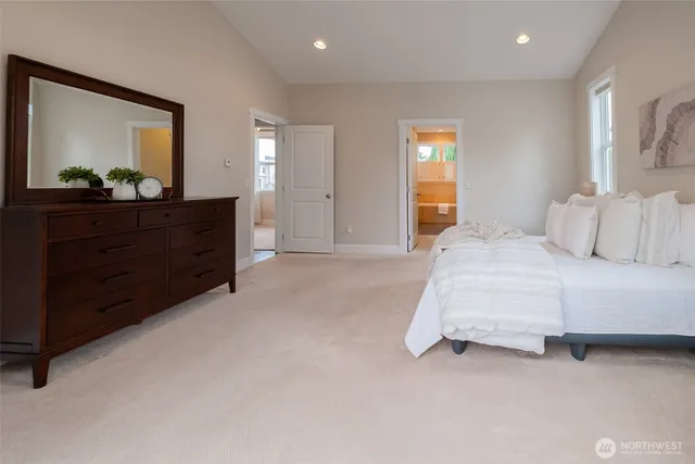 a bedroom with a bed and a mirror on dresser