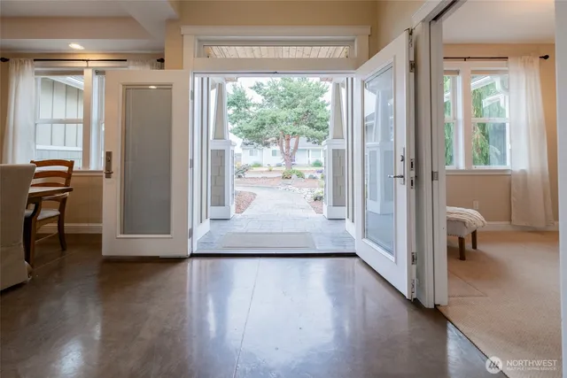 a view of a hallway with wooden floor and furniture