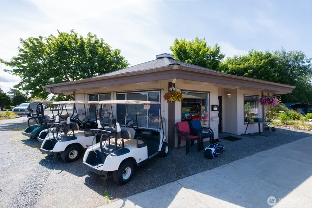 an aerial view of a residential houses with yard