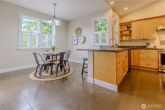 a kitchen with a table chairs and window