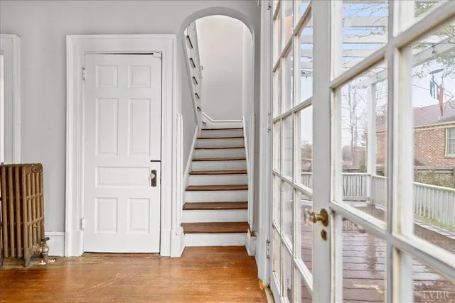 a view of an entryway with wooden floor and stairs