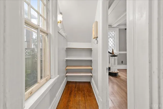 a view of a room with wooden floor and white walls