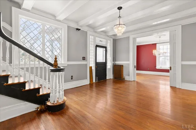 a view of empty room with wooden floor and fireplace