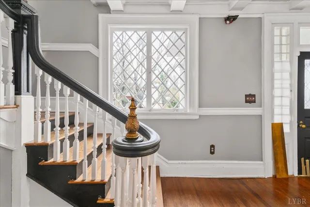 a view of a livingroom with wooden floor and a fireplace