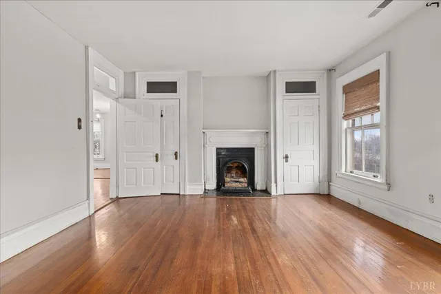 a view of a room with wooden floor
