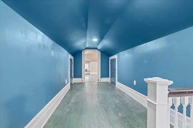 a view of a house with a wooden deck and furniture