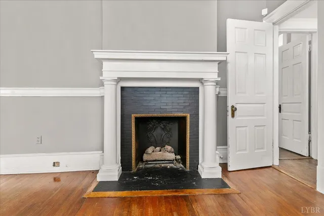a living room with a fireplace and a table