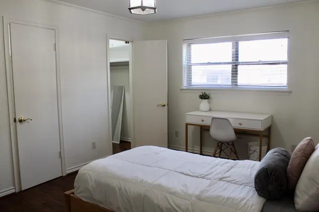 a bedroom with a bed and a window