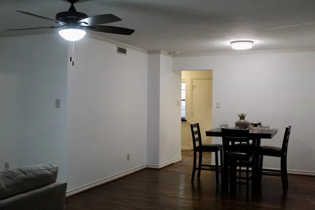 a view of a dining room with furniture and wooden floor