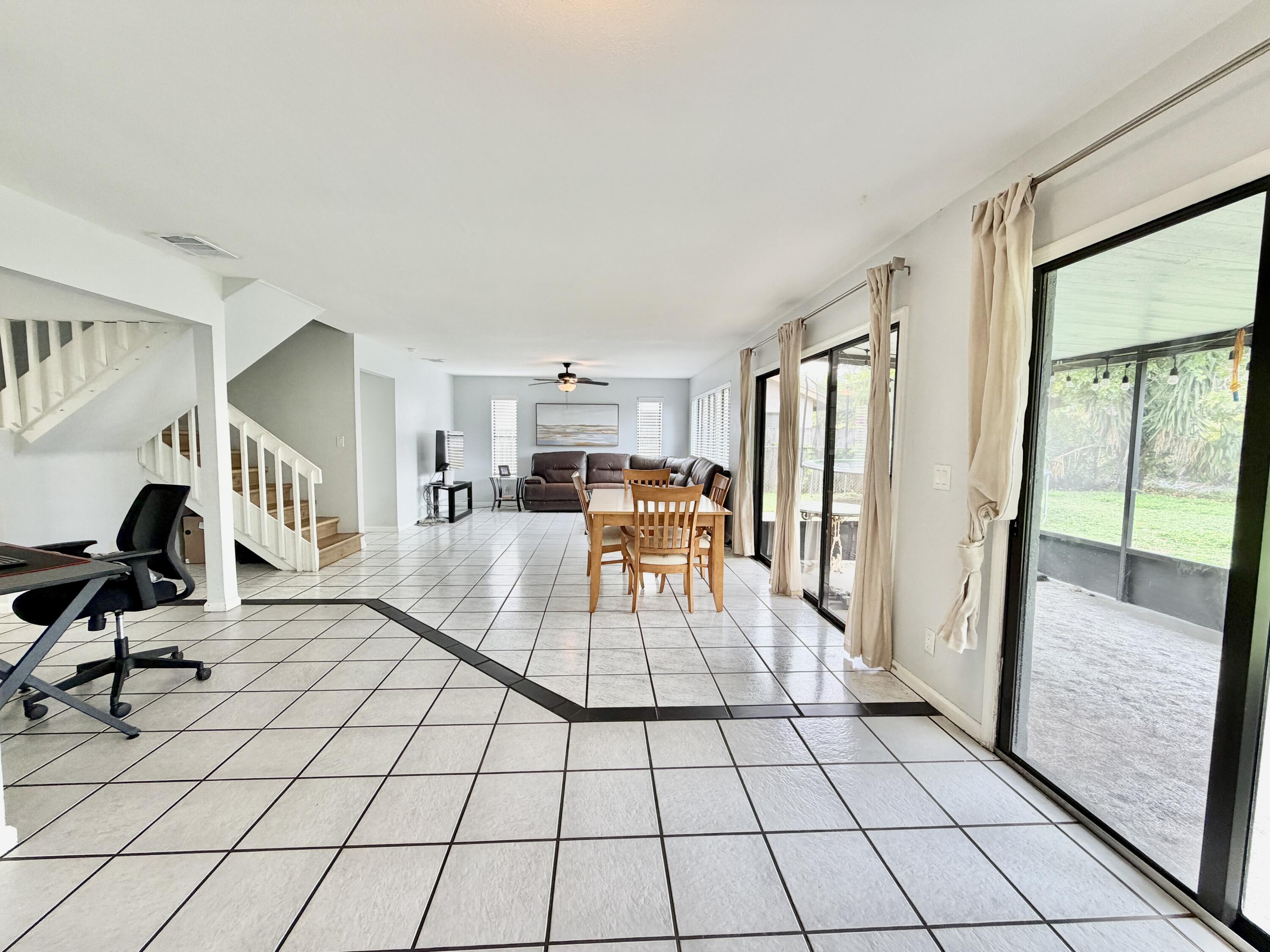 6048 Garrett Street Jupiter, FL 33458 - Photo 14 of 39 a living room with furniture and a table