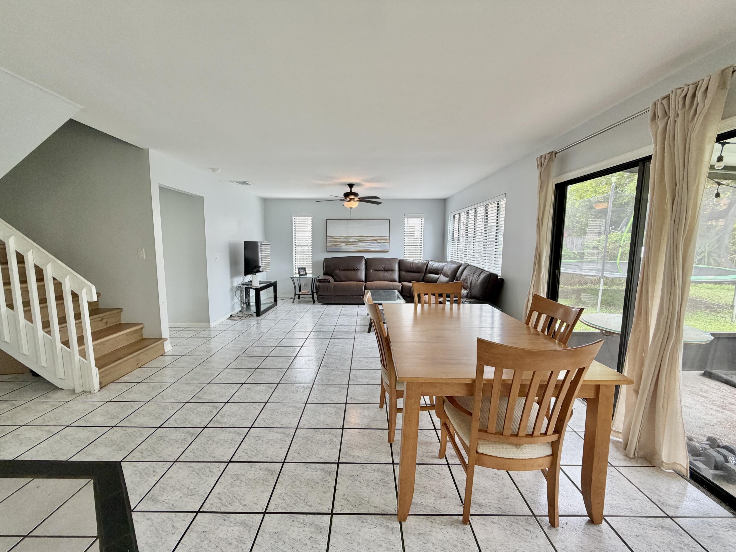 6048 Garrett Street Jupiter, FL 33458 - Photo 17 of 39 a view of a dining room with furniture and a livingroom