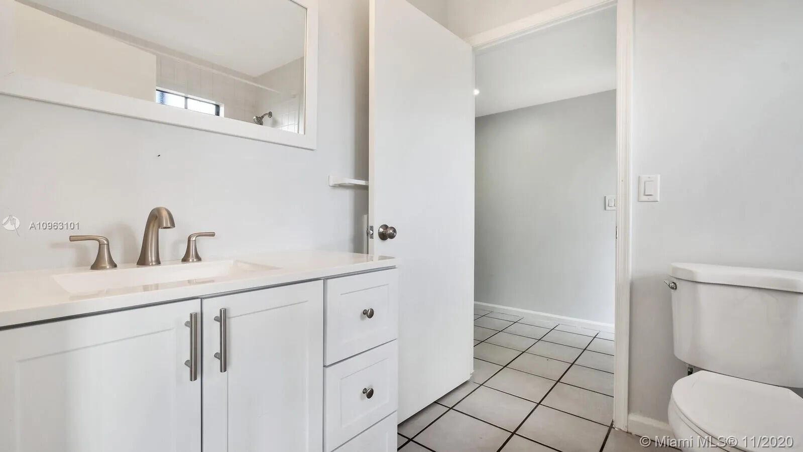 6048 Garrett Street Jupiter, FL 33458 - Photo 25 of 39 a bathroom with a sink a toilet and a mirror