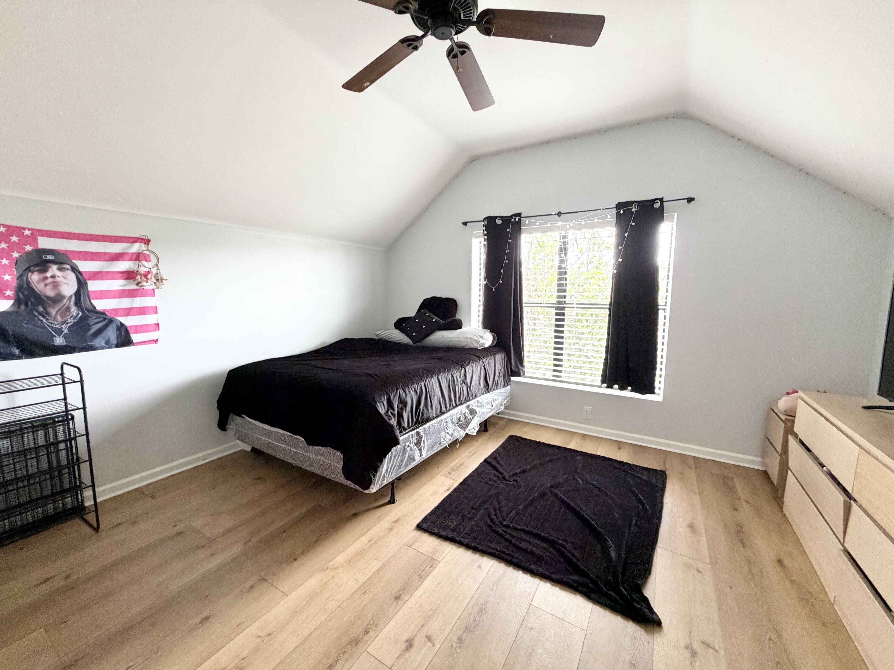 6048 Garrett Street Jupiter, FL 33458 - Photo 26 of 39 a bedroom with a bed lamp and a large window