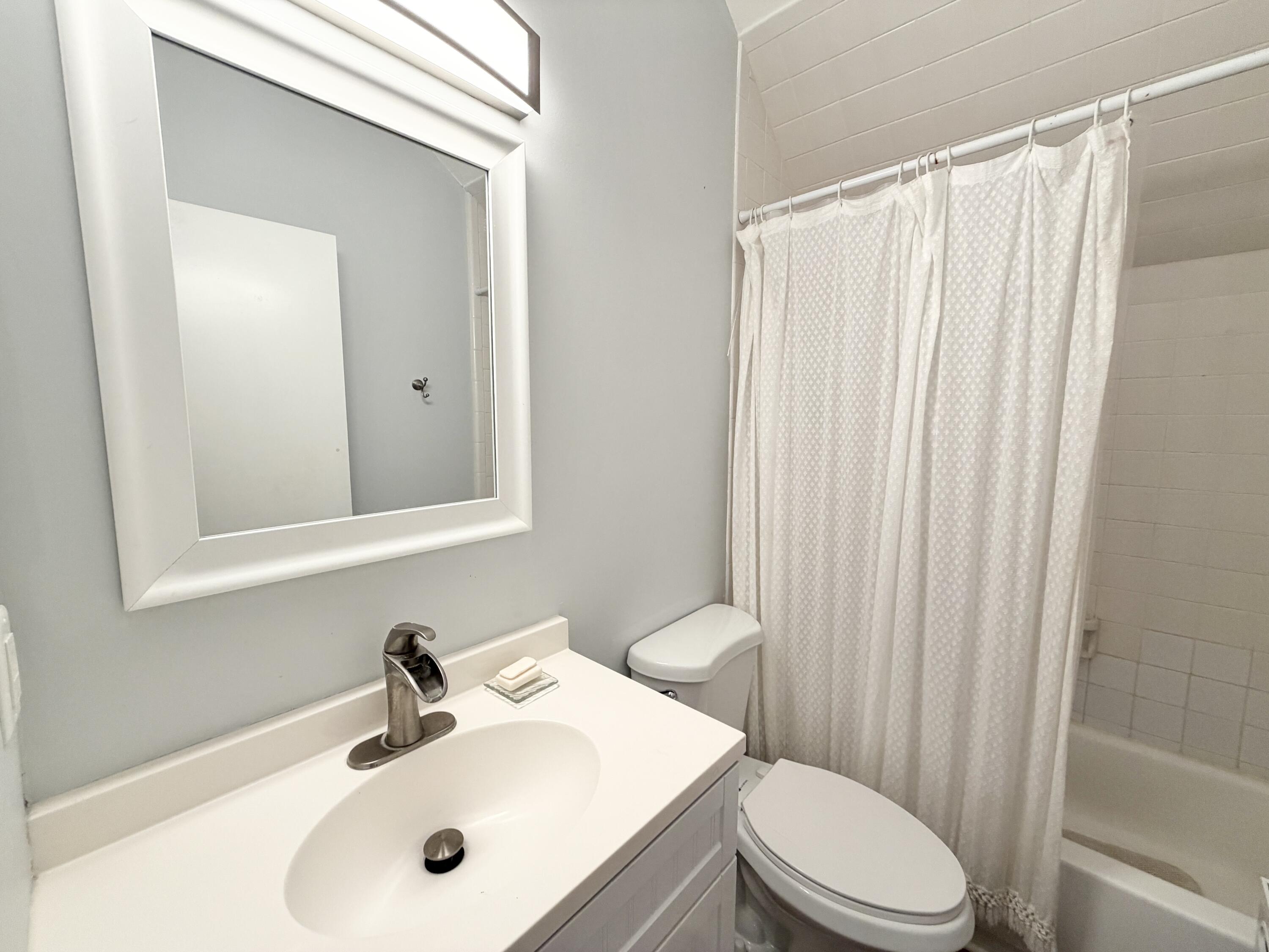 6048 Garrett Street Jupiter, FL 33458 - Photo 29 of 39 a bathroom with a sink toilet and shower