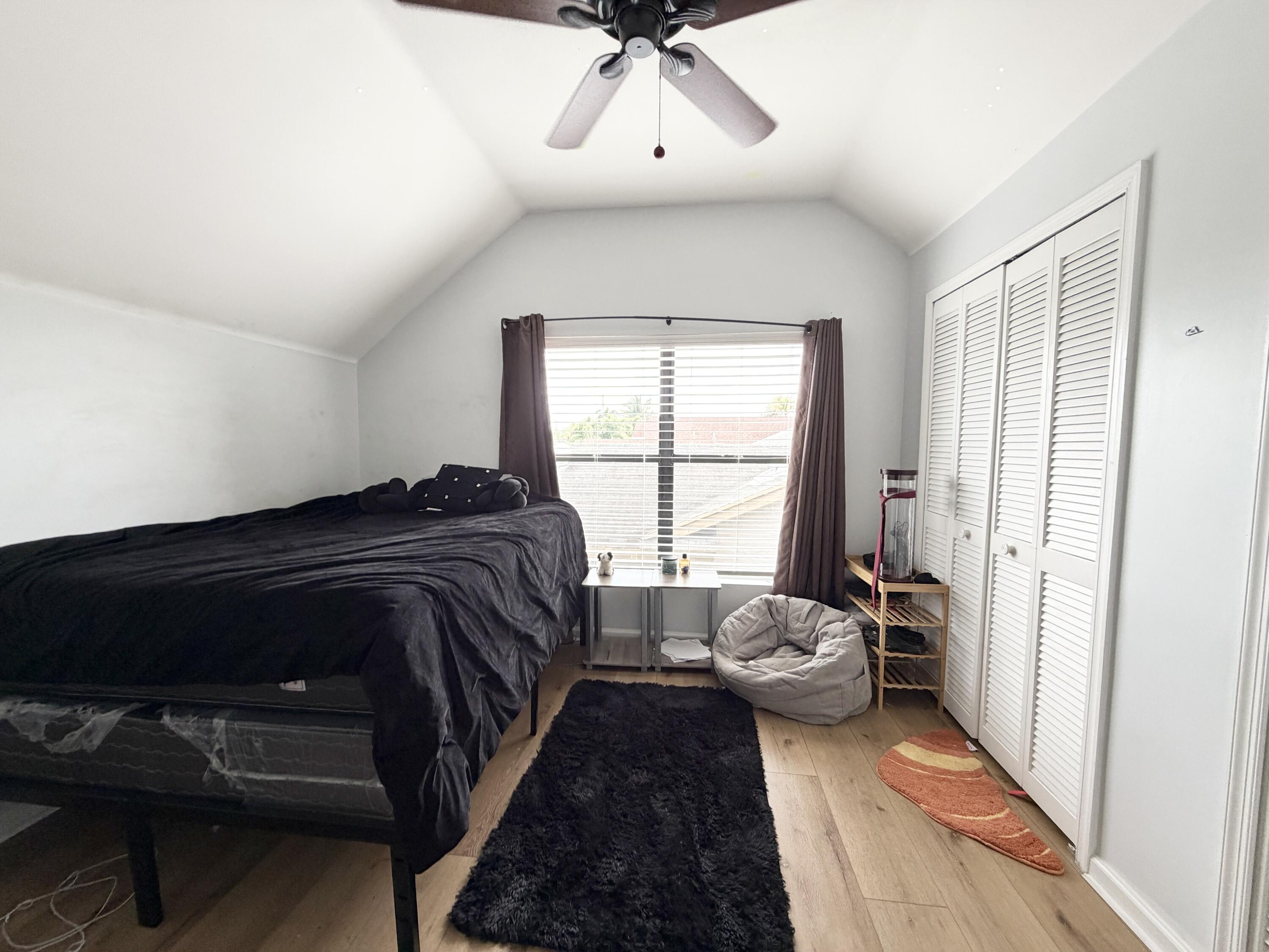 6048 Garrett Street Jupiter, FL 33458 - Photo 31 of 39 a bedroom with a bed and a window