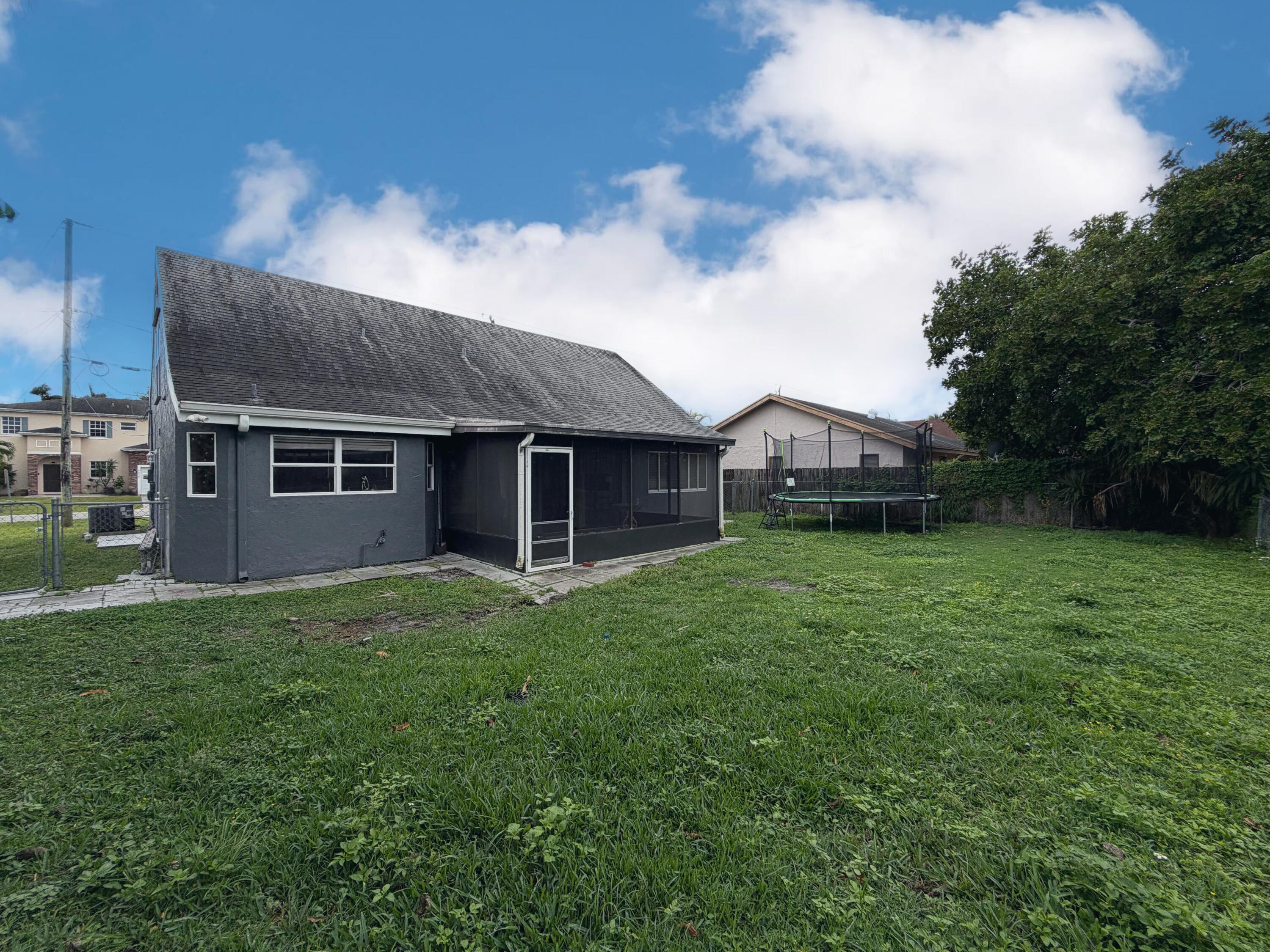 6048 Garrett Street Jupiter, FL 33458 - Photo 35 of 39 a view of a house with a back yard