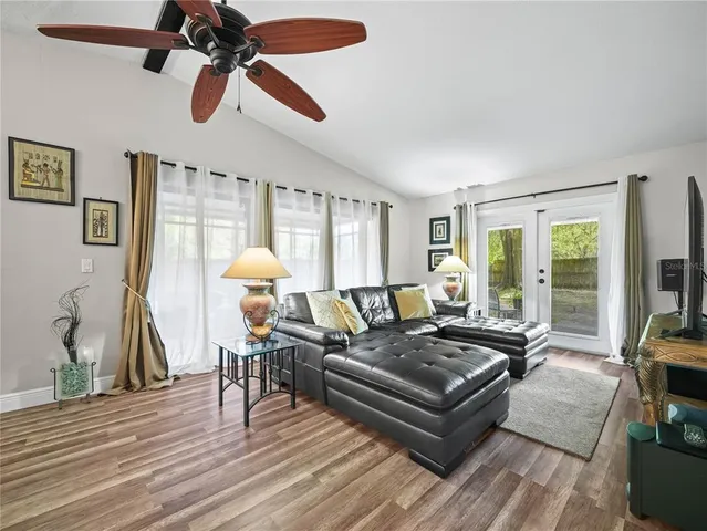 a living room with furniture and a wooden floor