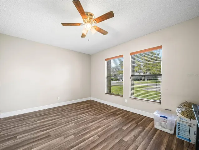 a view of a room with wooden floor and a window