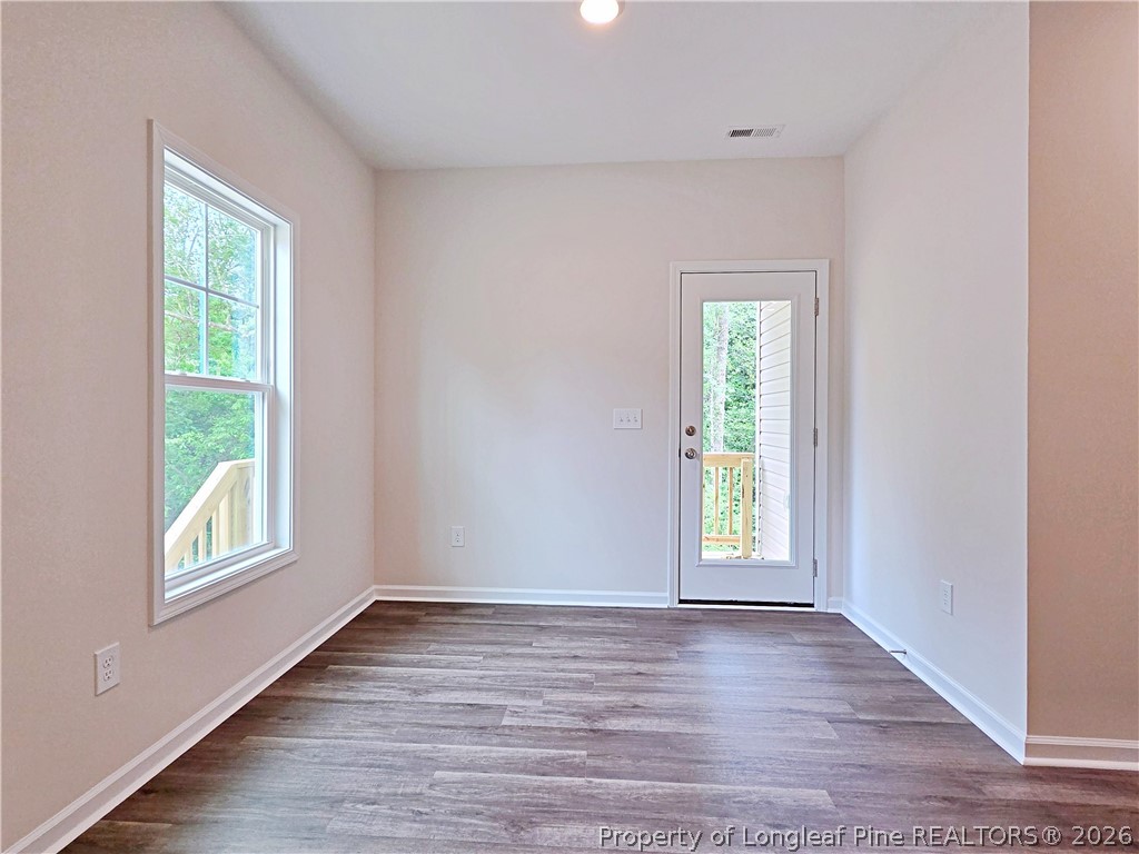 331 Appaloosa Drive Spring Lake, NC 28390 - Photo 11 of 29 an empty room with wooden floor and windows