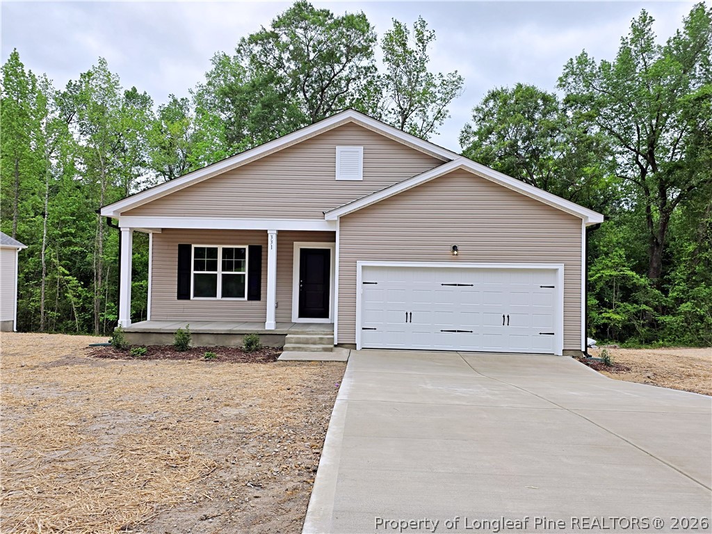 331 Appaloosa Drive Spring Lake, NC 28390 - Photo 25 of 29 a front view of a house with a garden