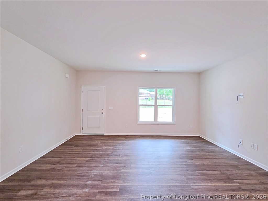 331 Appaloosa Drive Spring Lake, NC 28390 - Photo 3 of 29 a view of an empty room with wooden floor and window