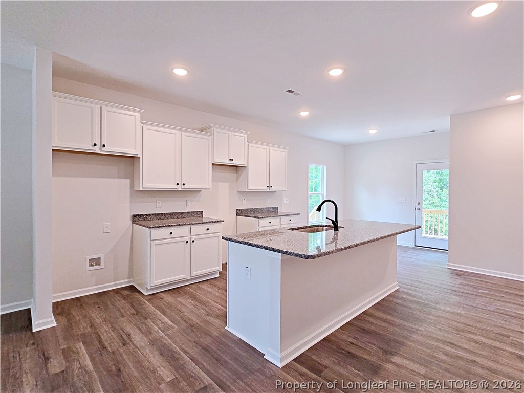 331 Appaloosa Drive Spring Lake, NC 28390 - Photo 7 of 29 a kitchen with granite countertop a sink and cabinets