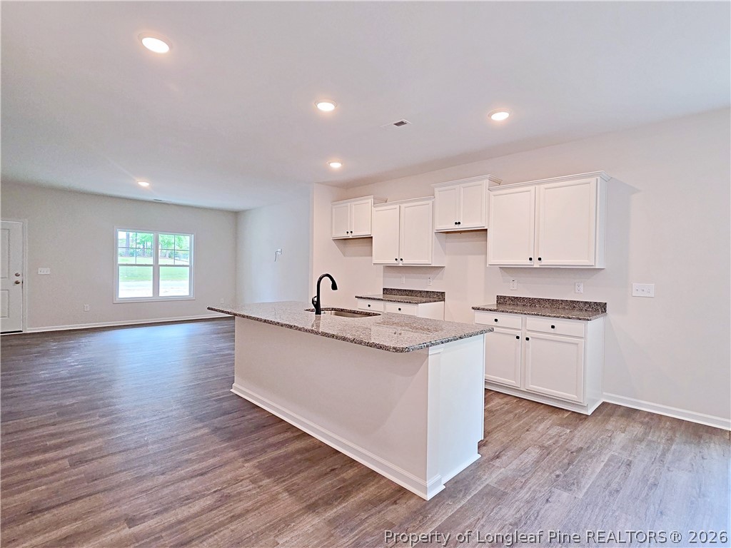 331 Appaloosa Drive Spring Lake, NC 28390 - Photo 8 of 29 a kitchen with stainless steel appliances granite countertop a sink a stove and cabinets