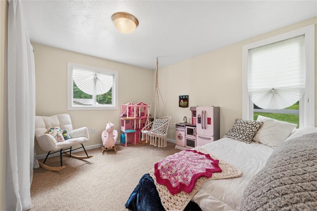 5380 Hardt Road Gibsonia, PA 15044 - Photo 22 of 49 The third bedroom with neutral tones on the main has two windows and has an overhead light as well.