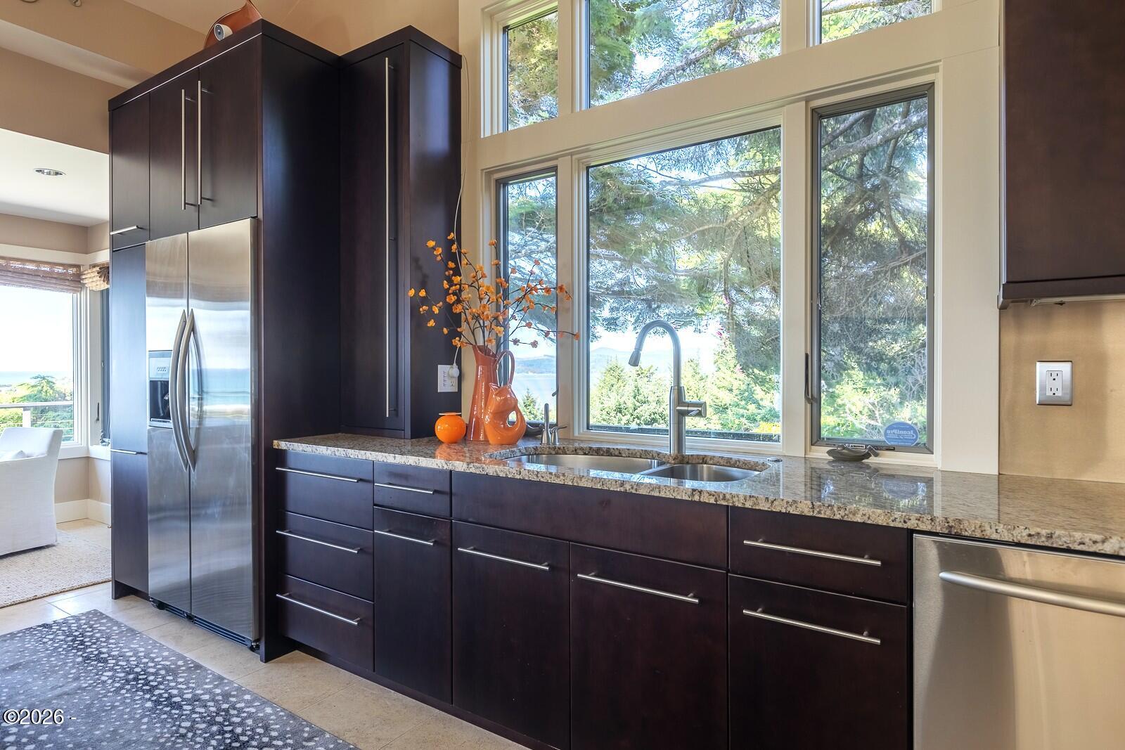 142 East Bay Point Road Gleneden Beach, OR 97388 - Photo 11 of 49 a kitchen with granite countertop a refrigerator and a sink