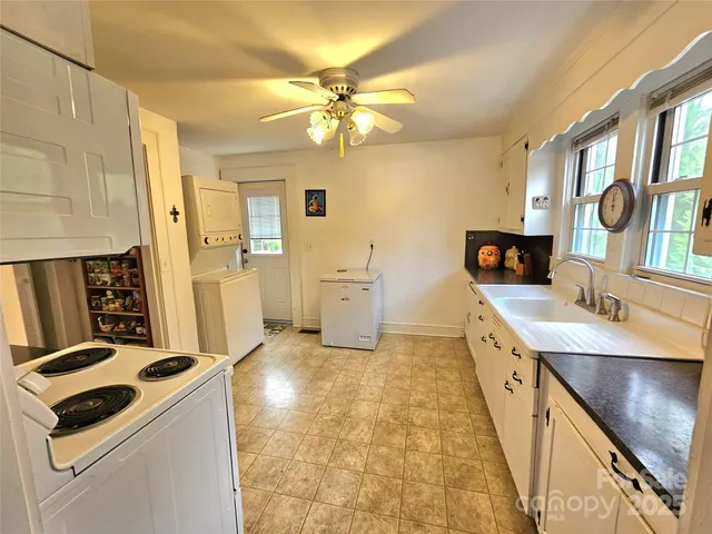 a kitchen with a sink appliances and cabinets