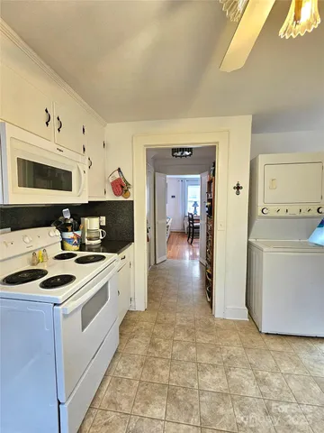 a kitchen with a stove a sink and a refrigerator