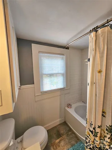 a view of bedroom with hardwood floor and bathroom