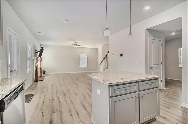 a kitchen with a sink dishwasher a refrigerator and a counter space