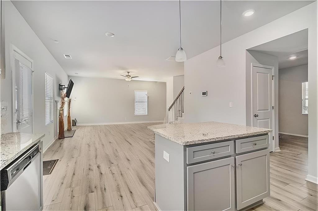 1101 Longleaf Trace Monroe, GA 30656 - Photo 14 of 36 a kitchen with a sink dishwasher a refrigerator and a counter space