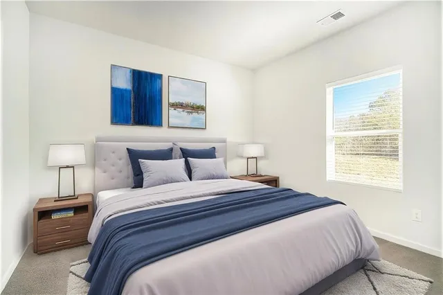 a bedroom with a bed and a night stand