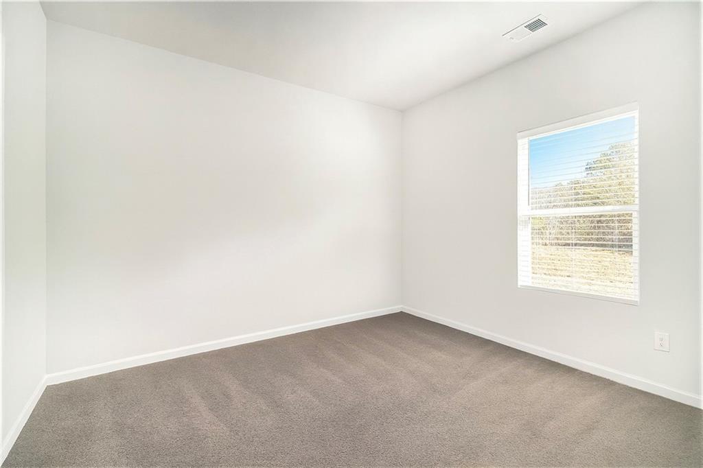 1101 Longleaf Trace Monroe, GA 30656 - Photo 18 of 36 an empty room with a window