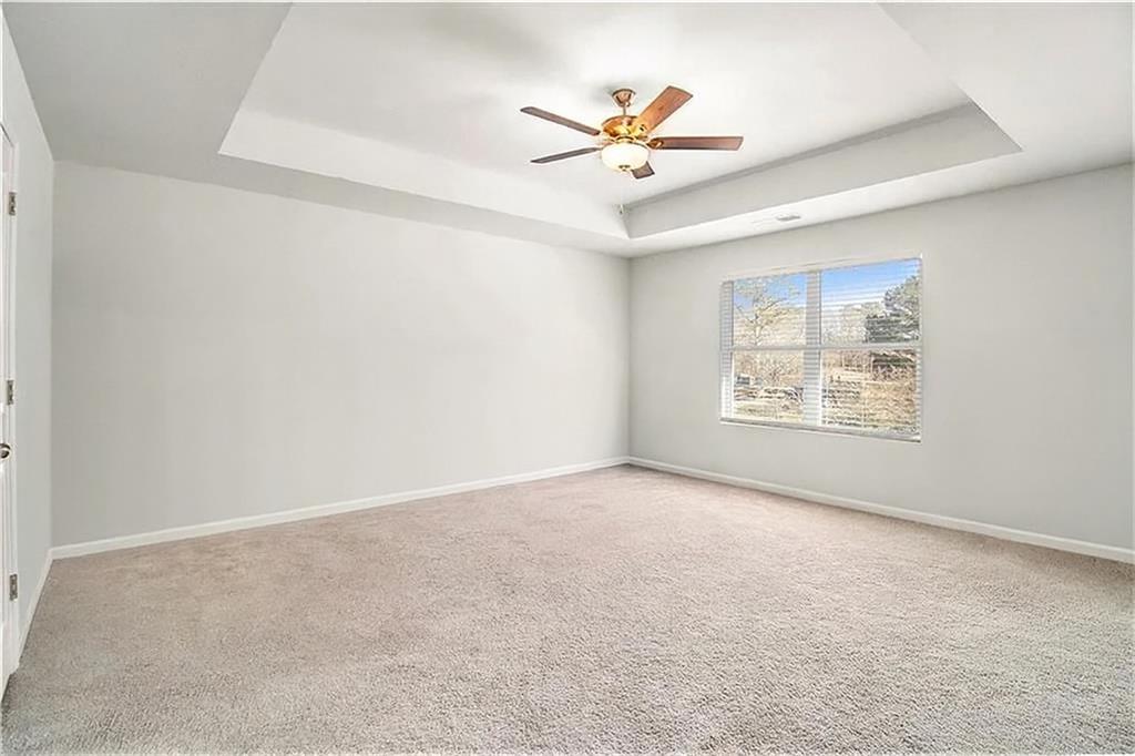 1101 Longleaf Trace Monroe, GA 30656 - Photo 23 of 36 an empty room with windows and fan