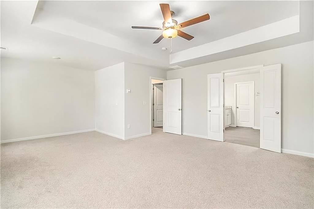 1101 Longleaf Trace Monroe, GA 30656 - Photo 24 of 36 an empty room with closet and a ceiling fan