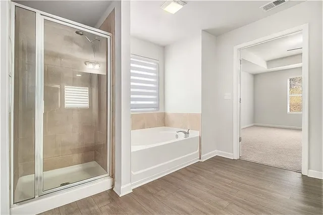 a bathroom with a bathtub and a shower