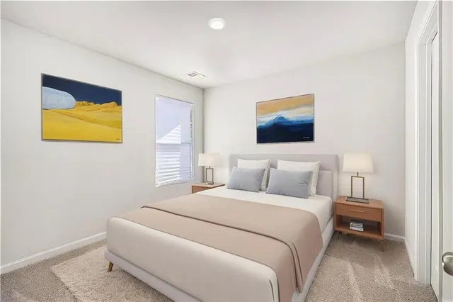 a bedroom with a bed and painting on the wall