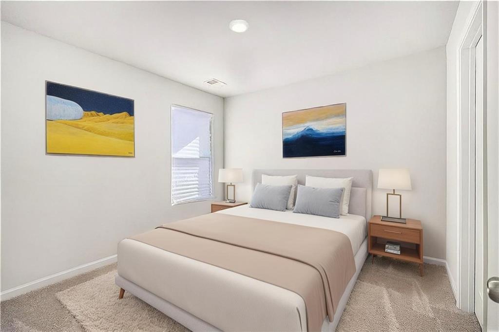 1101 Longleaf Trace Monroe, GA 30656 - Photo 27 of 36 a bedroom with a bed and painting on the wall