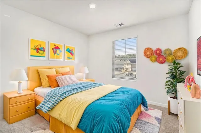 a bedroom with a bed and a painting on the wall